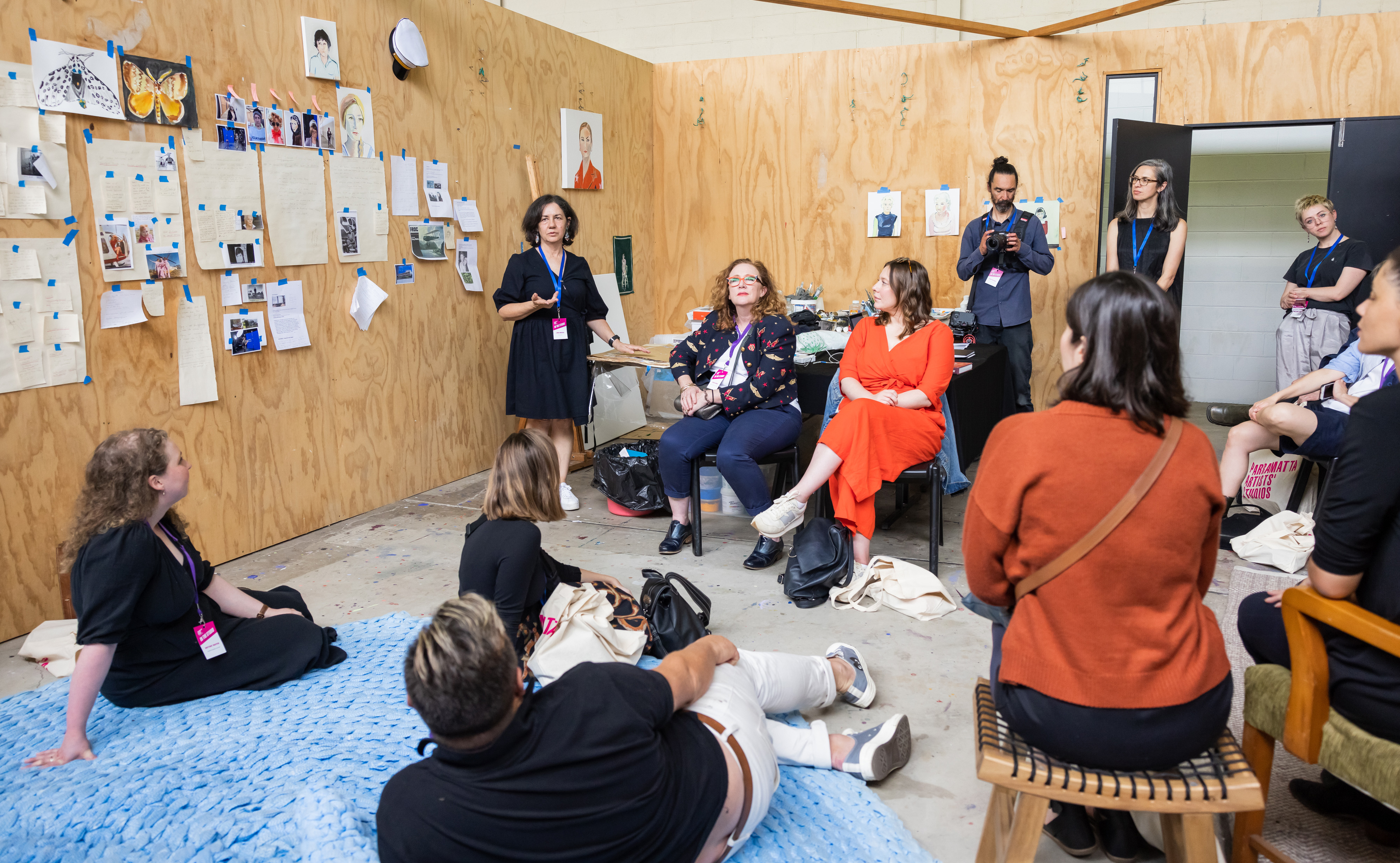 A group of people gathered in a wood panel room