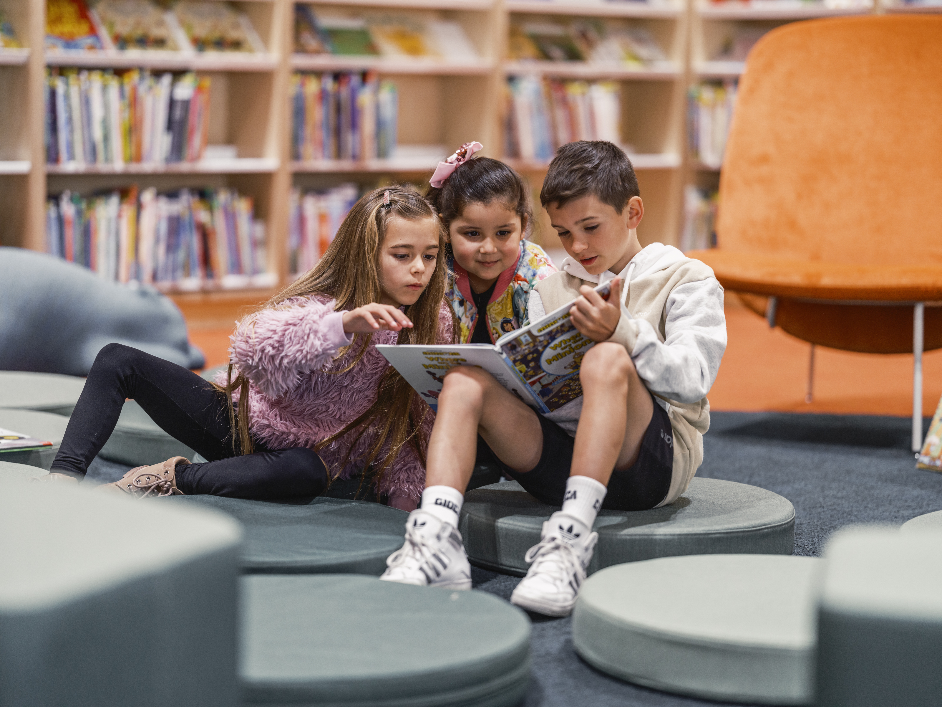 Young children reading a book