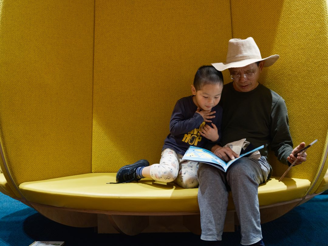 Two people reading in the library