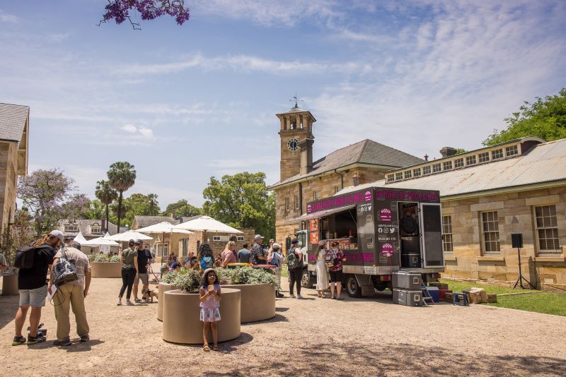 Family enjoying day, Food truck in front of old building 