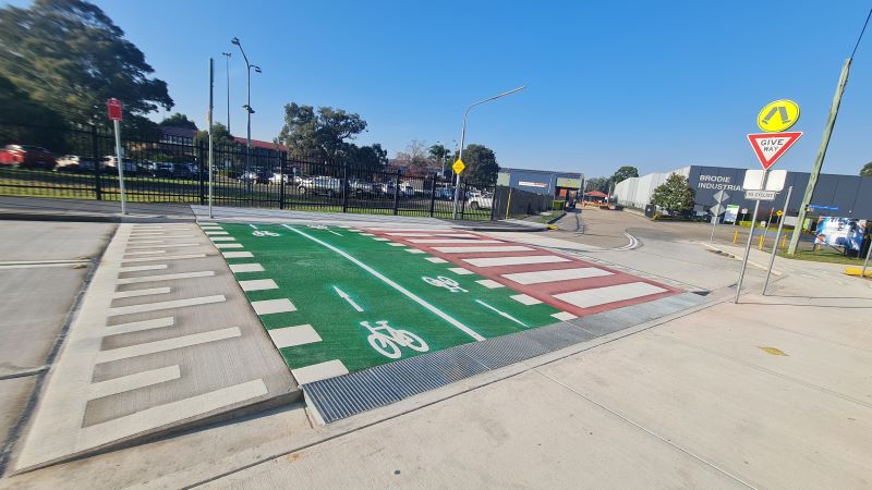 Raised crossing marked green for cyclists and red section for pedestrians