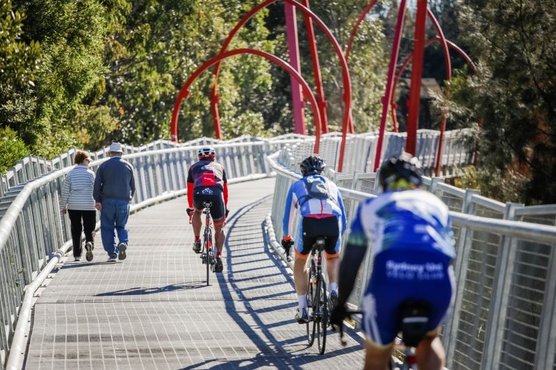 Women and Men riding on a track 