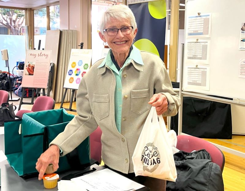 Elderly woman holding bag