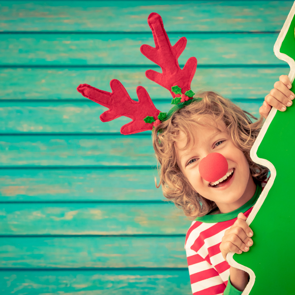 Child dressed in red and white strip t-shirt with antlers