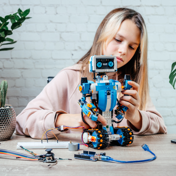 Girl putting a robot together