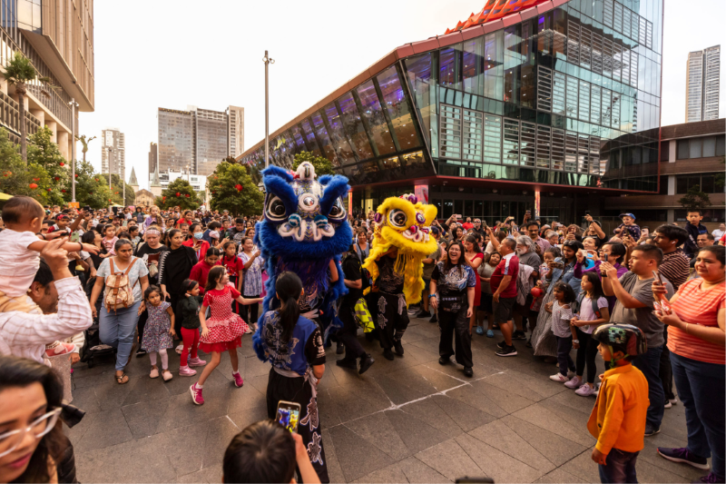 Blue and Yellow dragon with families celebrating Lunar New Year