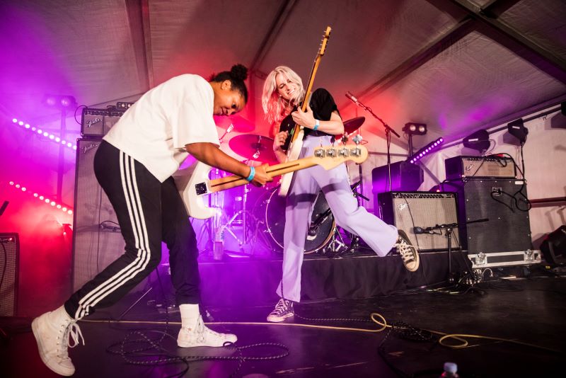 Two woman playing the guitar 