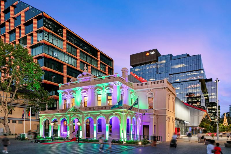 Town hall with green and purple lights on the front of the building