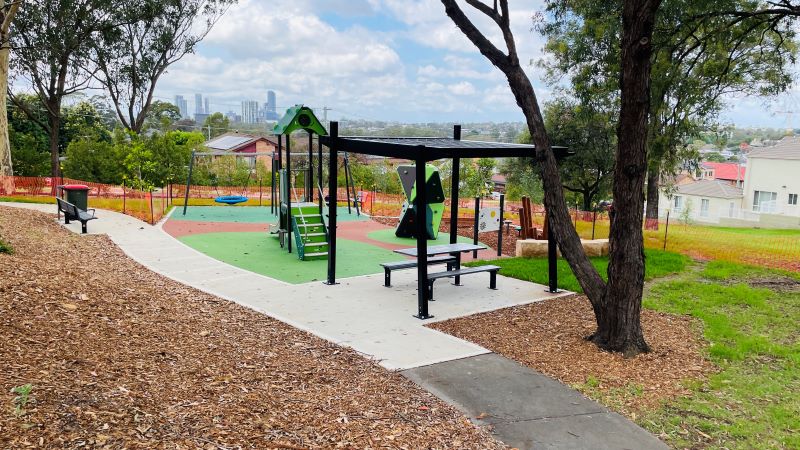 New playground with path and seating area