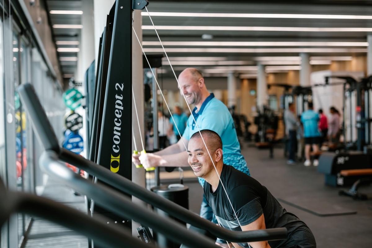 Two men using gym equipment