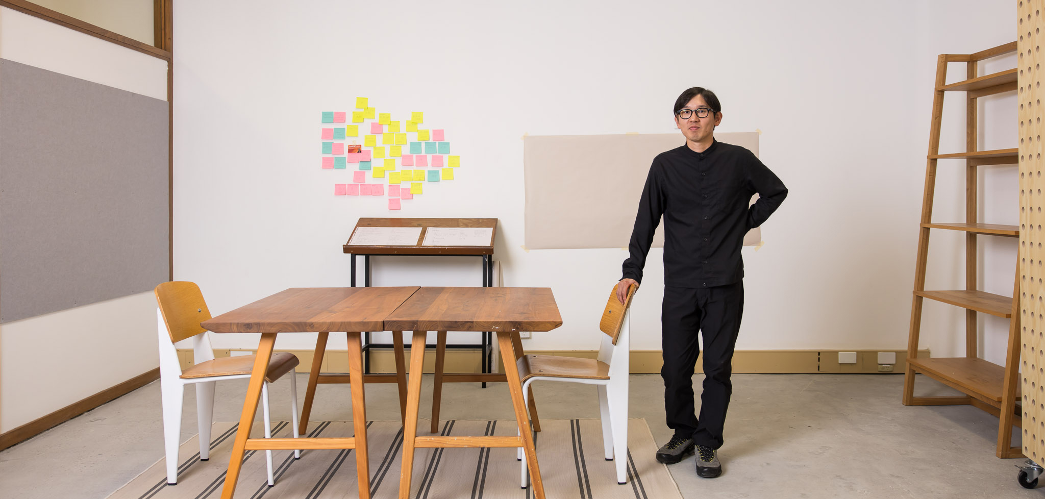 A man stands in a room filled with furniture