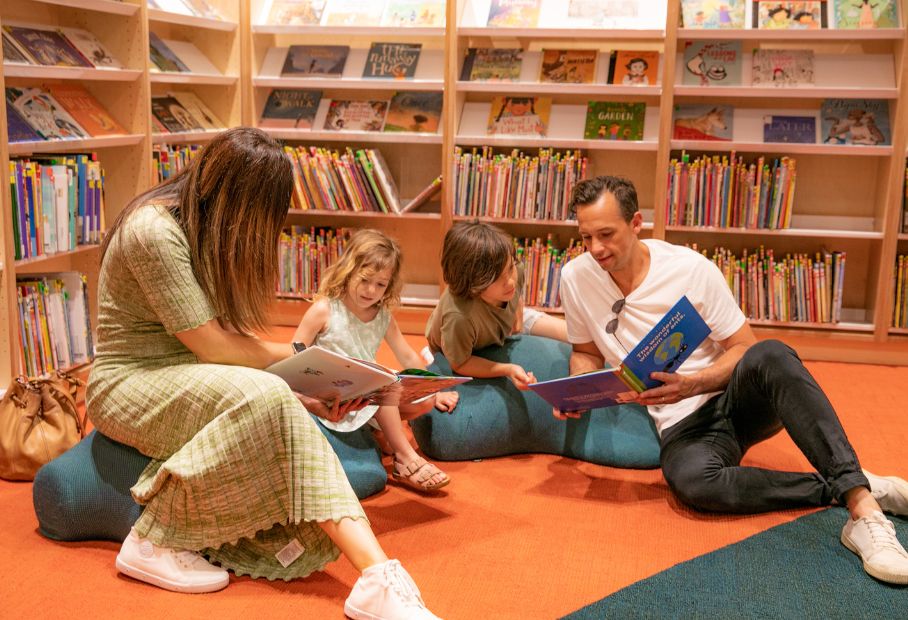 Mum and Dad reading books to children