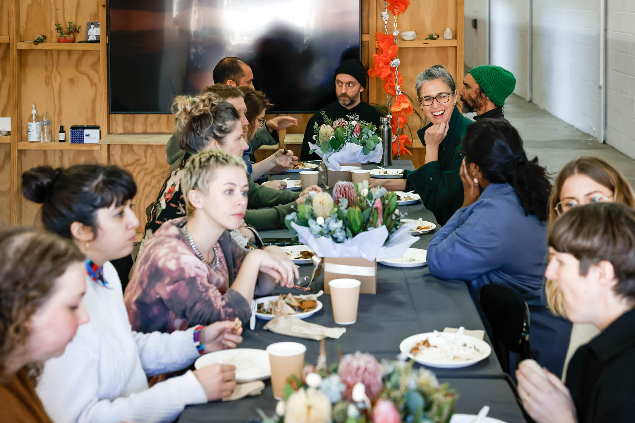 A group of people gathered eating food