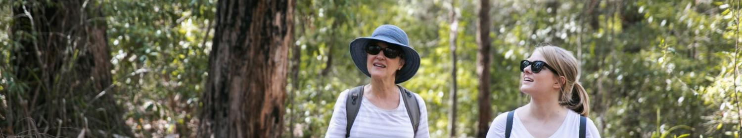 Two women walking in the bush